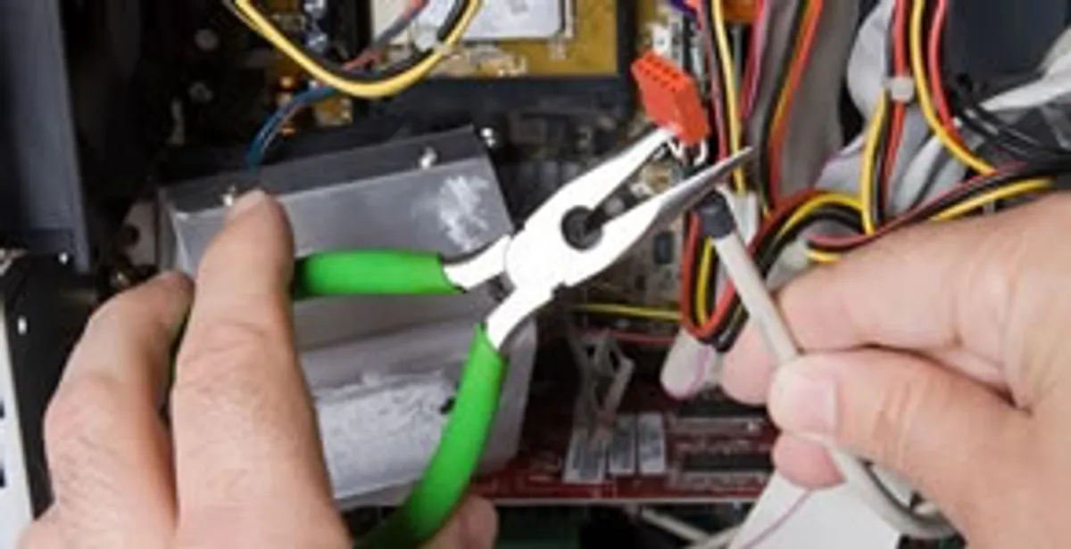 Licensed electrical contractor performing electrical repair with tools in Roxbury, MA
